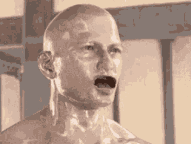 a statue of a man with his mouth open is looking at the camera .