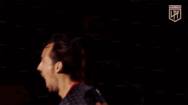 a soccer player is scratching his head with his hand while wearing a mask .