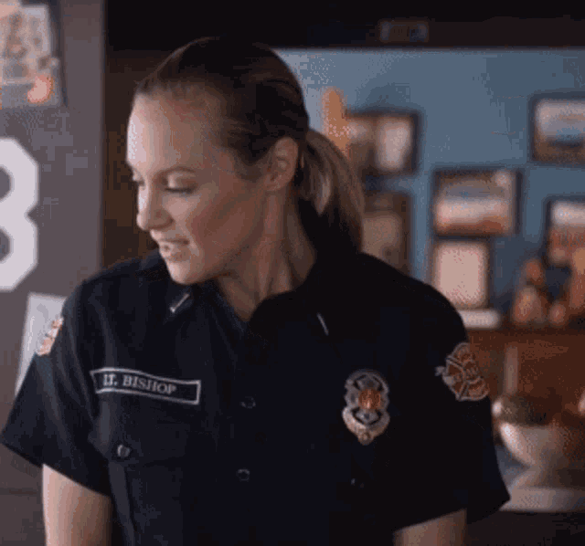 a woman in a police uniform with the name h. bishop on her shirt