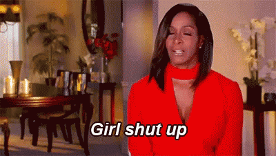 a woman in a red jacket is sitting in a living room with her eyes closed and says `` girl shut up '' .