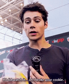 a young man is holding a microphone and says if i did watch it oh i broke your cookie