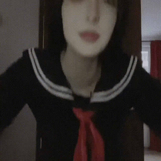 a woman with a mask on her face is wearing a sailor uniform and a red tie