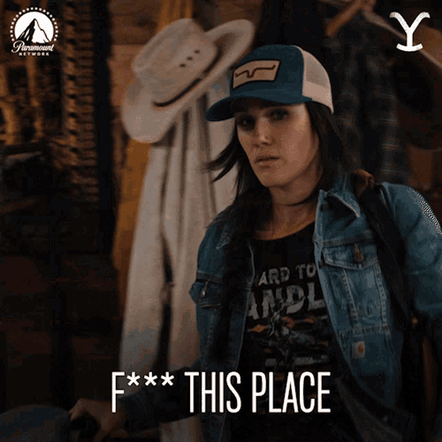 a woman wearing a blue hat and a denim jacket says f * * this place