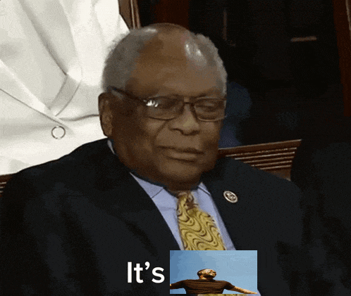 a man in a suit and tie is sitting next to a picture of a man and the words it 's