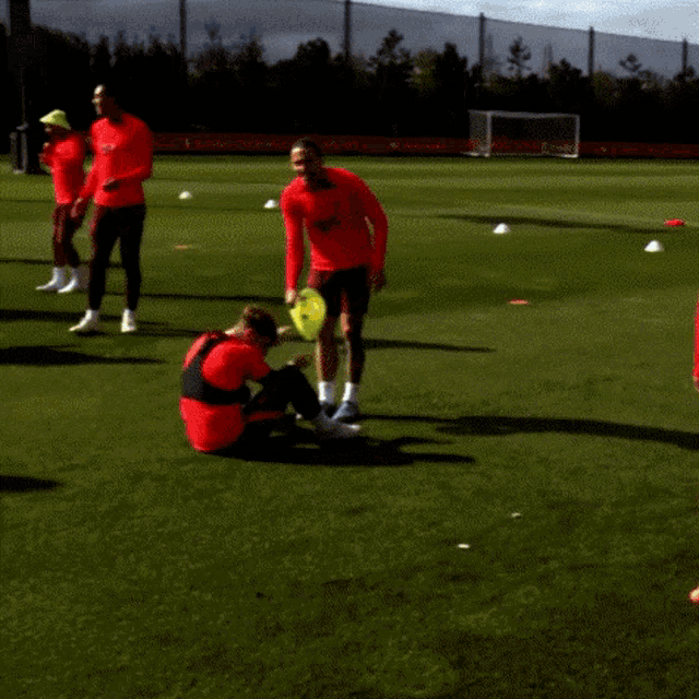 a group of soccer players are on a field and one of them is wearing a shirt that says ' santander '