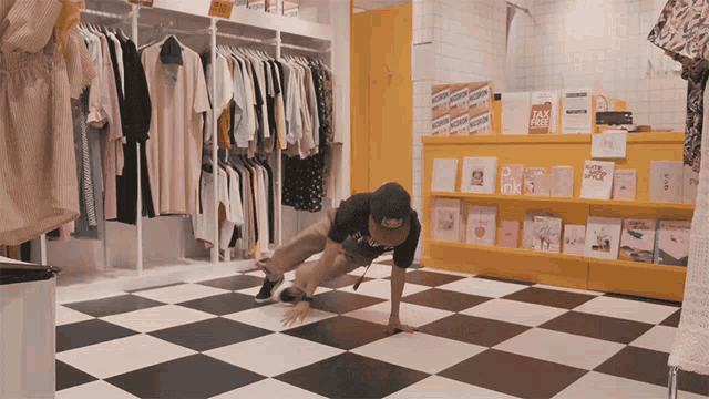 a man doing push ups in a store with a sign that says tax free on it