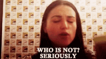 a woman says who is not seriously in front of a wall