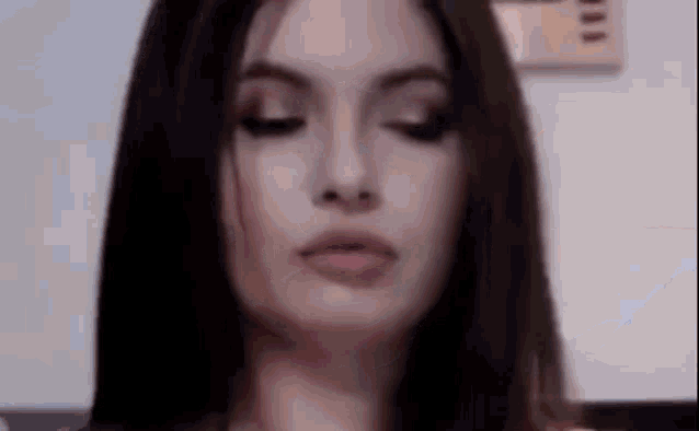 a close up of a woman with her eyes closed and her mouth open .