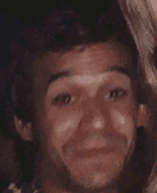 a close up of a man 's face with a smile on it
