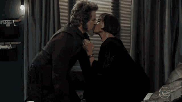two women are kissing on a bed with a sign that says jane