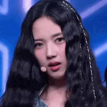 a close up of a woman with long black hair