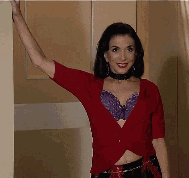 a woman wearing a purple bra and a red top