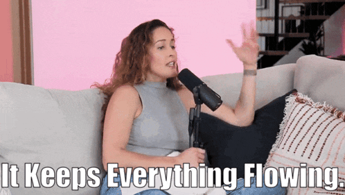 a woman sitting on a couch talking into a microphone with the words " it keeps everything flowing " below her