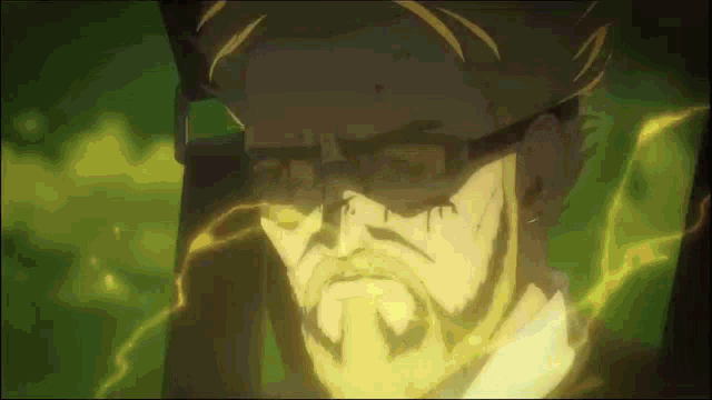a man with glasses and a beard is standing in a dark room .