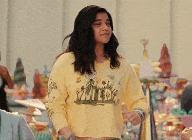 a girl wearing a yellow shirt with the word mind on the front