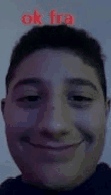 a close up of a young man 's face with a purple background and the words `` ok fra '' written on it .