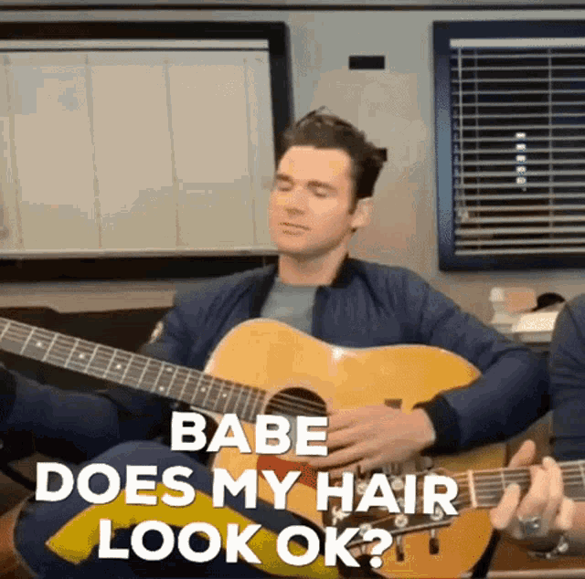 a man is playing a guitar and says babe does my hair look ok .