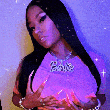 a woman wearing a purple shirt with a barbie necklace around her neck