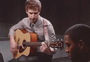 a man playing an acoustic guitar with a caption that says shreks