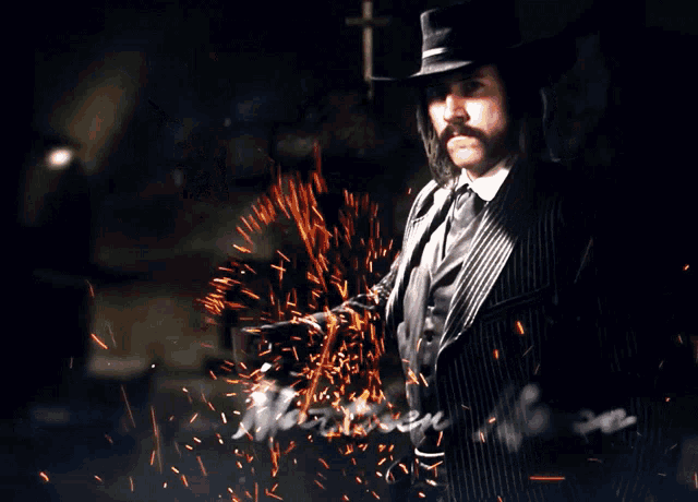 a man in a suit and hat is holding a gun and the name matthew mercer is below him