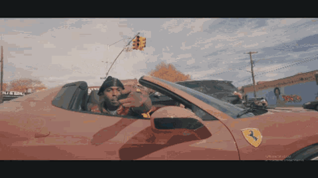 a man is driving a red car with the number 3 on the side