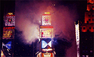 a toshiba happy new year sign is lit up in a city at night