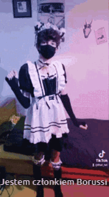 a person in a maid costume is wearing a face mask