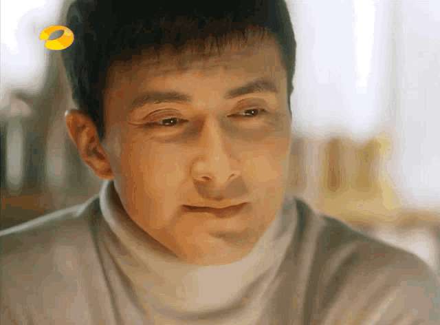 a close up of a man 's face with a yellow circle behind him