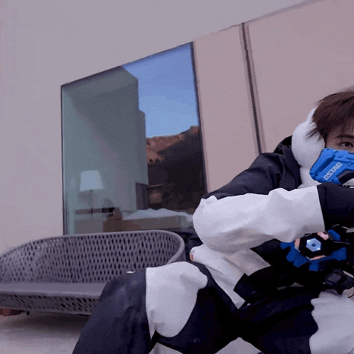 a person wearing a mask and gloves that say ' ecstar ' on them