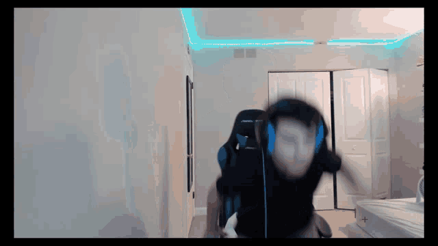 a person wearing headphones is sitting in a chair