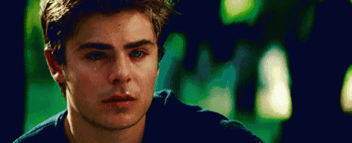 a young man is crying with a tear coming out of his eye .
