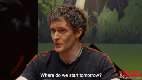 a man wearing a dungeons and dragons shirt says where do we start tomorrow