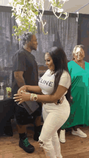 a woman wearing a white celine shirt is dancing