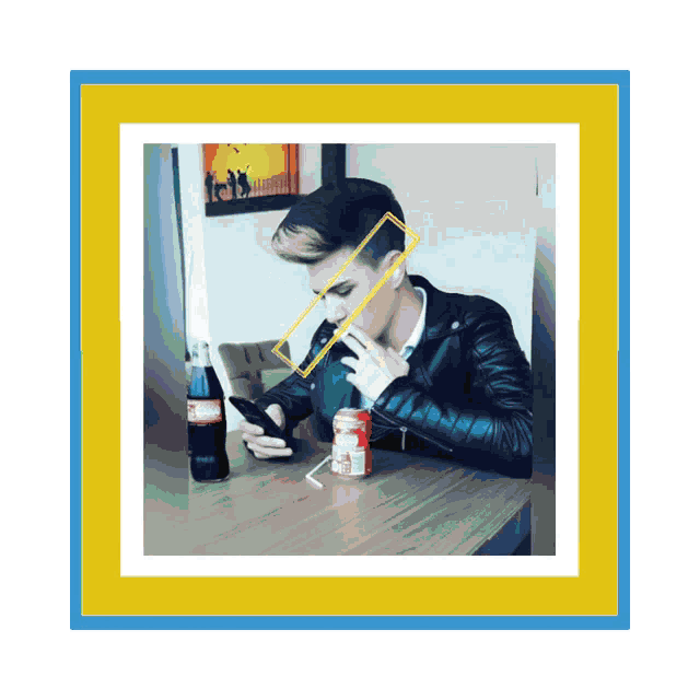 a man sits at a table with a coca cola bottle and a can of soda