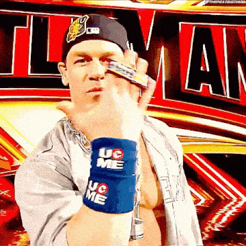 a wrestler wearing a hat and wristbands that say uc on them