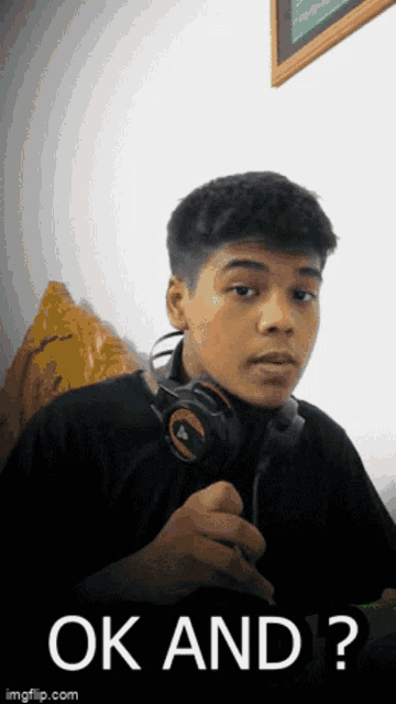 a young man wearing headphones and a black shirt says ok and