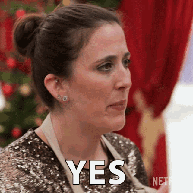 a woman in a sequined top has the word yes on her face