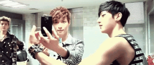 a man is taking a picture of himself in a mirror .