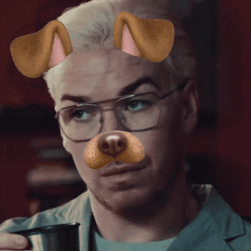 a man wearing glasses and a dog face filter drinks from a mug