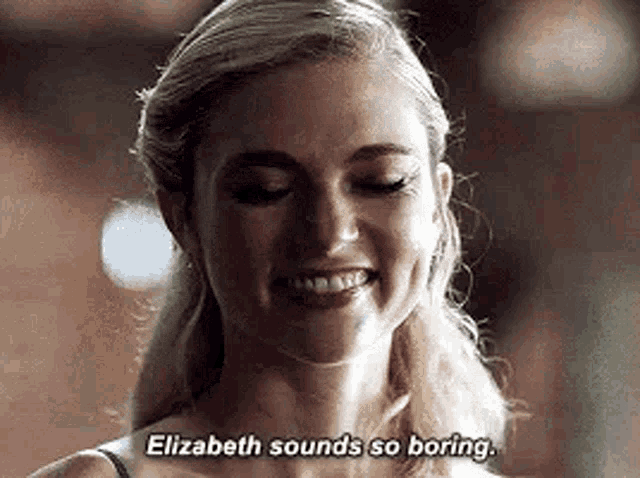 a close up of a woman smiling and saying `` elizabeth sounds so boring '' .