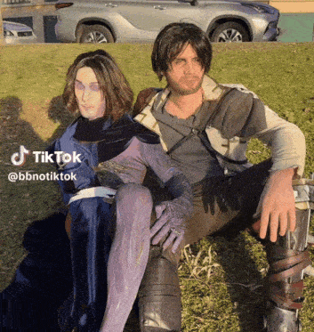 a couple of people sitting in the grass with a tiktok watermark on the bottom right
