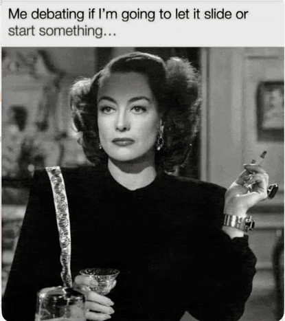 a woman is smoking a cigarette and drinking a martini .