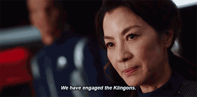 a woman says " we have engaged the klingons " in front of a man