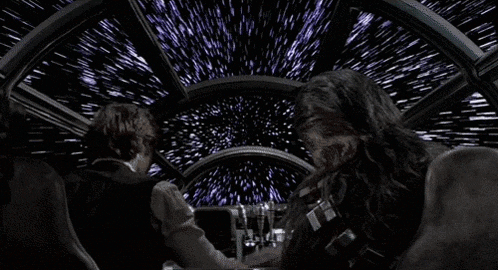 han solo and chewbacca are sitting in the cockpit of the millennium falcon .