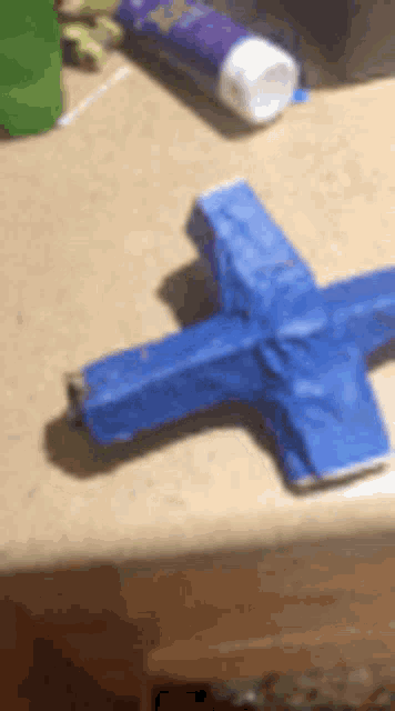 a blue object is sitting on top of a counter next to a tube of toothpaste .