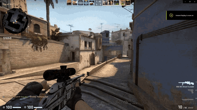 a person holding a sniper rifle in a video game with a screen that says instant replay