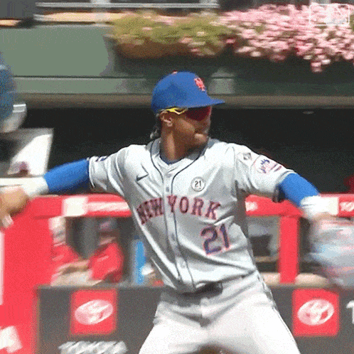 a man wearing a new york jersey and a blue hat