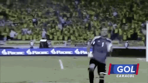 a soccer player with the number 1 on his jersey runs on the field