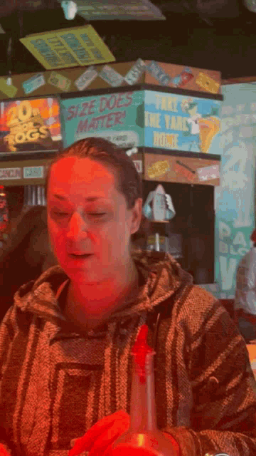 a woman sitting at a table with a sign that says size does matter