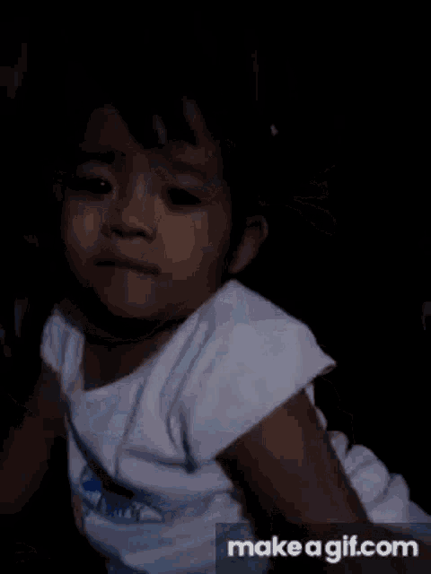 a close up of a baby 's face with make a gif.com in the bottom right corner